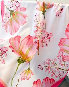 Detailed view of floral silk satin scarf with pink flower patterns and vibrant rolled edges