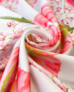 Close-up of floral print silk scarf showing smooth texture and glossy satin finish