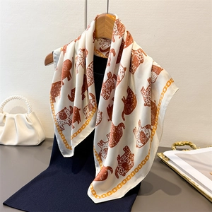 Retro silk square scarf featuring orange elephant patterns and gold chain borders