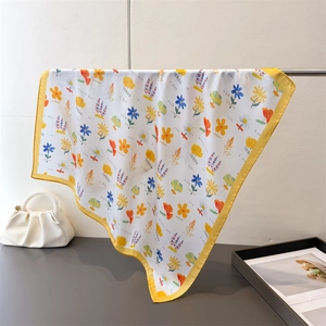 Floral printed silk scarf featuring yellow borders and decorative romantic typography