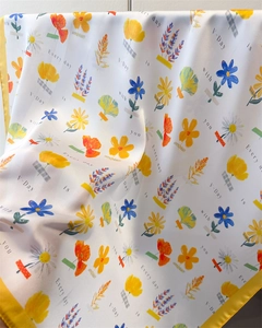 Detail of floral silk-feel scarf with daisy print and rolled edge stitching