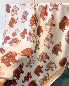 Close-up of silk scarf showing vintage elephant prints and orange chain border