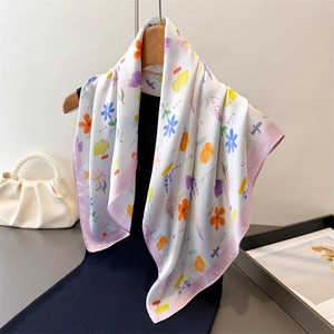 Elegant white floral silk scarf with pink borders on black dress display