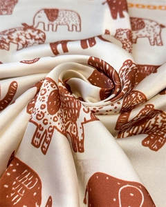 Detailed swirl of silk scarf with retro elephant print and smooth satin texture