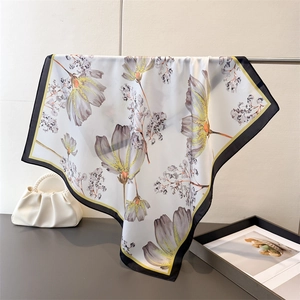 Close-up of floral silk-feel scarf with elegant botanical prints and high-gloss finish