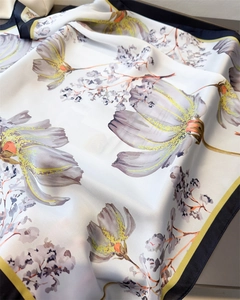 Close-up of floral print silk scarf showing soft fabric texture and satin finish