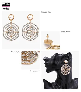 Detailed display of mesh gold earrings with sparkling crystals and pearl stud accents