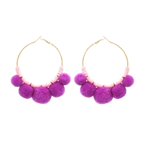 Bohemian gold hoop earrings with pink beads and five purple pom-poms on white background