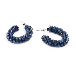 Macro detail of Bohemian C-shape hoop earrings with deep blue faceted crystal beads