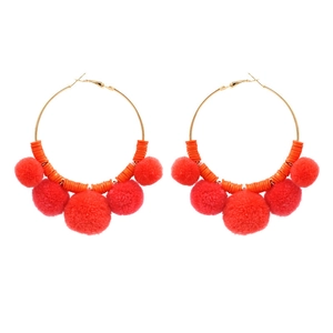 Bohemian large hoop earrings with orange beads and vibrant red pom-poms on gold circles