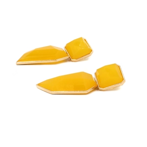 Detailed close-up of yellow resin geometric earrings with gold-toned metal frame
