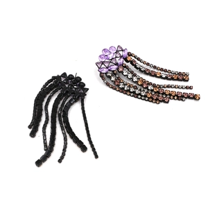 Detail view showing front and back of bohemian tassel earrings with purple crystals