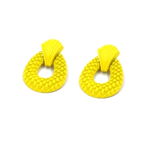Detail of yellow scallop-shaped stud earrings with textured oval pineapple pattern