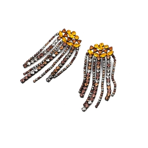 Macro view of long fringe tassel earrings featuring amber and coffee crystals