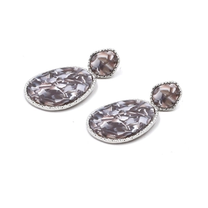 Detail of silver drop earrings with grey marble resin texture and metallic trim