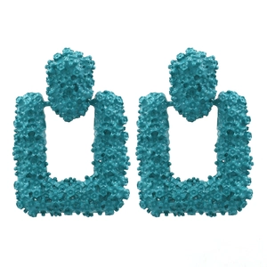 Auffällige übergroße türkisfarbene Ohrringe mit Blumenstruktur und geometrischem Design