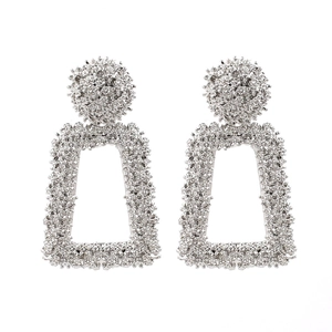 Detailed view of silver trapezoid earrings with shimmering micro-bead metal texture