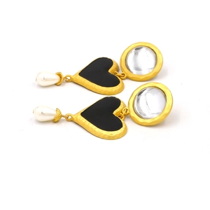 Detail of vintage gold earrings with black heart charms and drop faux pearls