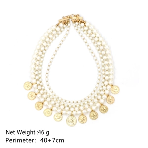 Detail of four-layer pearl necklace with vintage gold coin pendants and portrait relief