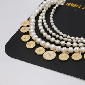 Chic multilayer pearl necklace featuring tiered strands with vintage gold coin pendants