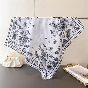 Detail of floral and bird print square silk scarf with polka dot border and pearl bag
