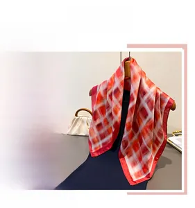 Macro detail of elegant red and white plaid silk scarf with classic vintage pattern
