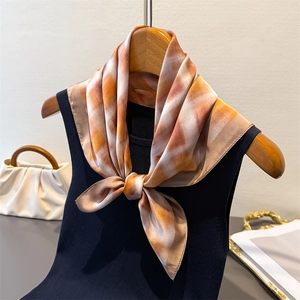 Detail of vintage plaid silk scarf tied on a ribbed vest with watercolor ombre pattern