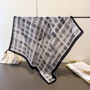 Close-up of vintage black and white plaid silk scarf texture with wide black border