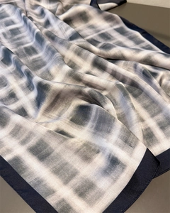 Detail of vintage gradient plaid silk scarf showing smooth texture and navy border