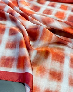 Close-up of vintage plaid silk scarf showing red and orange gradient fabric texture