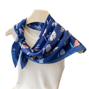 Vintage floral silk satin square scarf with daisy print tied on a mannequin neck