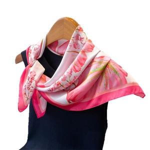 Pink floral faux silk square scarf draped on black top with elegant flower pattern