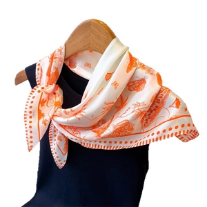 Elegant white and orange floral silk scarf with butterflies hanging on a wooden hanger