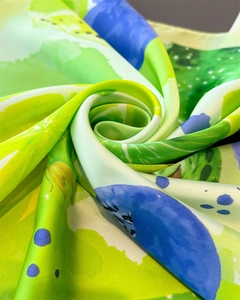 Detailed macro view of vibrant lemon print silk scarf showing smooth satin texture and luster
