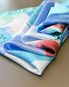 Detailed view of luxury lemon print silk scarf featuring abstract vibrant painted textures