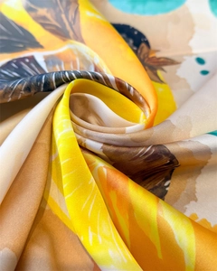Detailed view of lemon print silk scarf showing soft fabric texture and glossy finish