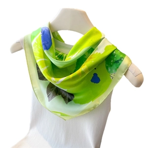 Vibrant lemon print green silk scarf with blue and yellow patterns on white background