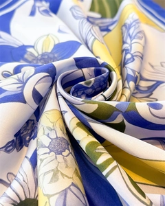 Macro detail of elegant floral silk scarf showing smooth texture and artistic draping