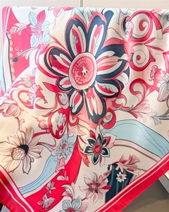Close-up of floral print silk scarf showing soft texture and premium edge stitching