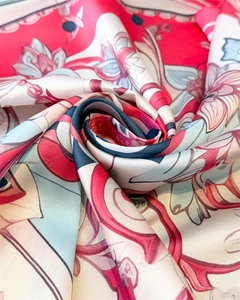 Detailed close-up showing silky satin texture and vintage floral print on a red shawl