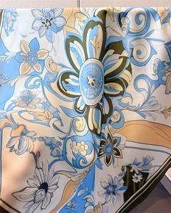 Close-up detail of satin floral scarf showing smooth texture and elegant blue patterns