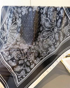 Detailed texture of semi-transparent paisley print scarf with elegant draping effect