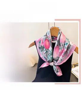 Detail of elegant floral silk scarf with pink fruit print and premium hand-rolled edges