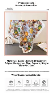 Detail showing high-quality satin polyester silk scarf with lemon and flower print patterns