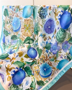 Detail of floral and lemon printed silk square scarf with vibrant blue borders