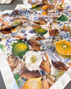 Detailed close-up showing silk texture and Mediterranean lemon tile print on square scarf