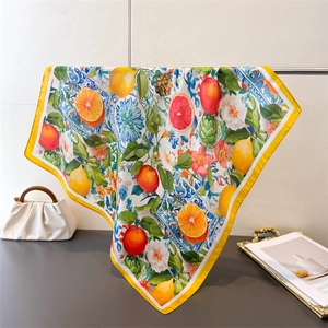 Detail of vibrant Mediterranean silk square scarf with colorful lemon and floral prints