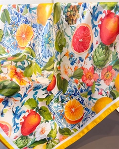 Detailed view of silk scarf with lemon, citrus fruit prints and Mediterranean tile patterns