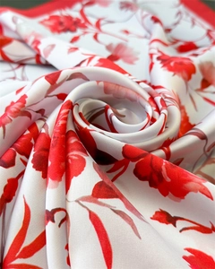 Detailed macro shot of silky satin scarf fabric with elegant red floral print