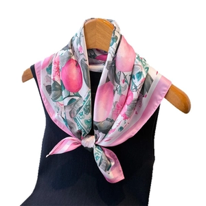 Elegant floral silk scarf with pink citrus print and green leaves on black clothing
